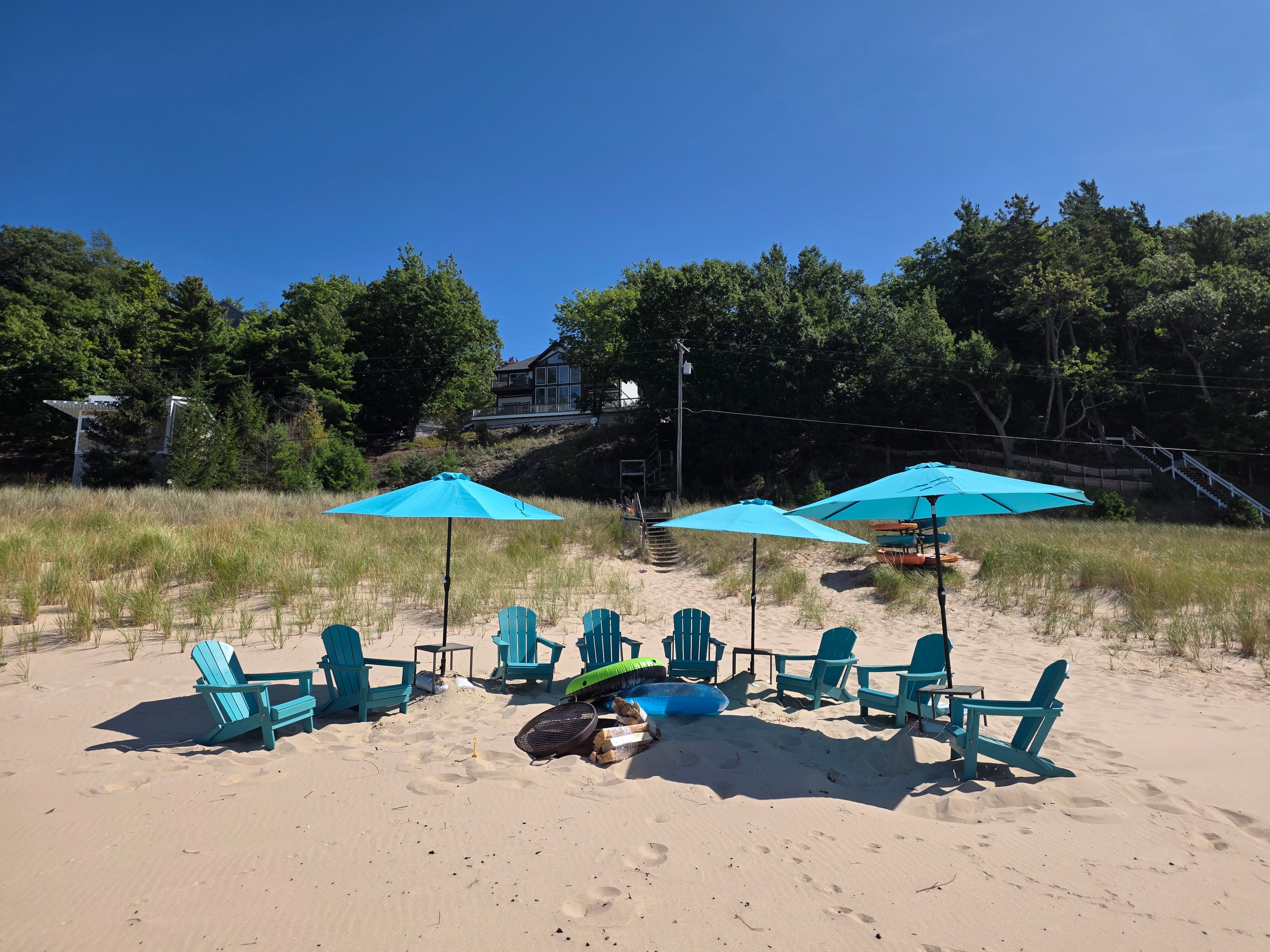 Adirondack chairs and fire pit on beach