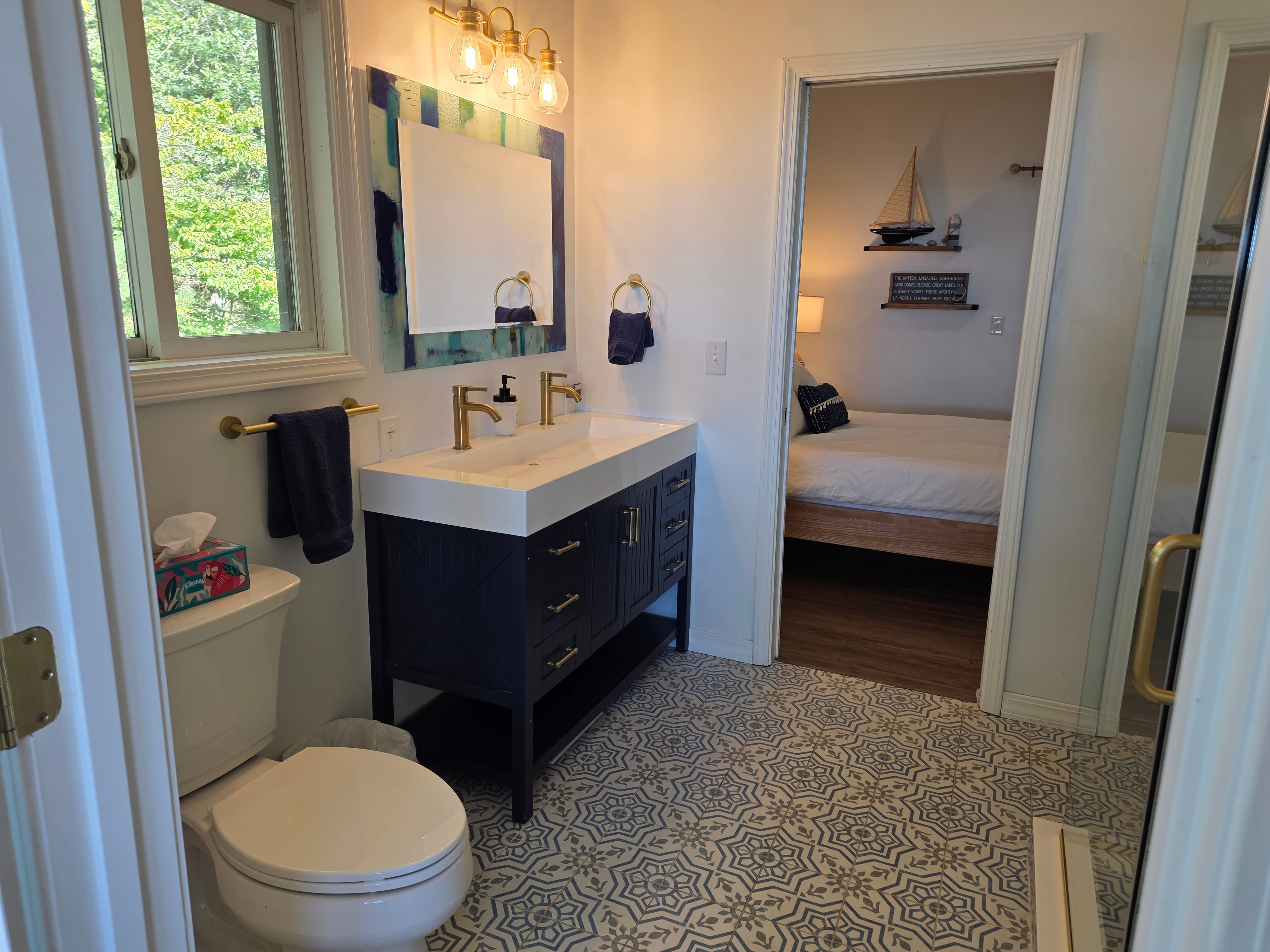 Bathroom with black vanity and brass fixtures